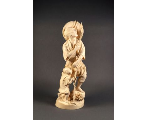 A Japanese carved ivory figure of a spear fisherman, with a coolie hat at his shoulders, a child at his side and with waves b