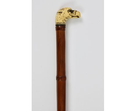 A carved ivory topped eagle head walking cane, late 19th / early 20th century, the bamboo shaft with carved ivory eagle head 