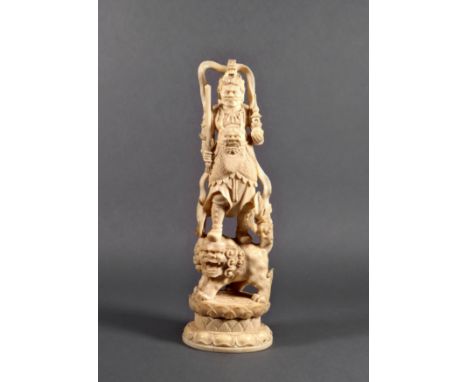 A Chinese carved ivory figure of a warrior immortal, Qing Dynasty, standing on the back of a Dog of Fo (Shishi), holding in o