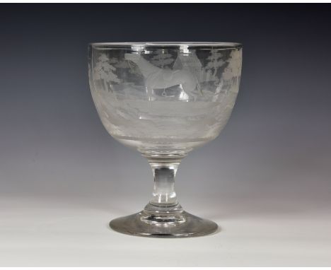 An early 19th century oversized ornamental glass goblet, the large cup bowl wheel engraved with a continuous fox hunting scen