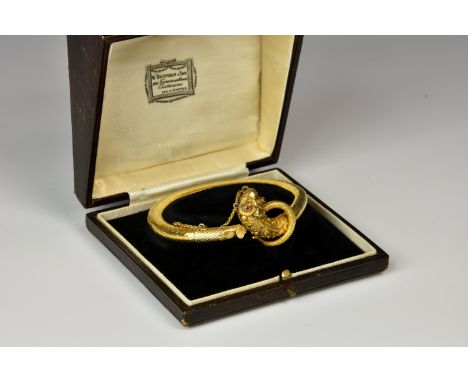 An antique Indian 22ct gold and ruby flexible snake bracelet, the finely articulated bracelet with decorative snake's head te