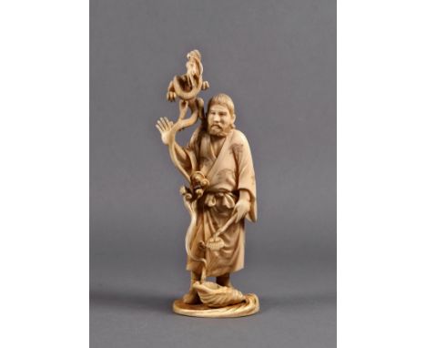 A Chinese carved ivory figure of a raku, Qing Dynasty, the bearded figure standing with a dragon at his shoulder, which arise