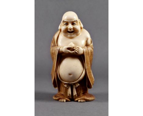 A Japanese carved ivory okimono of Hotei holding a peach, Meiji period (1868-1912), standing in coloured and textured robes, 