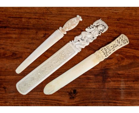 Three Chinese Canton carved ivory page turners, 19th century, one with blade carved with auspicious objects against a diaper 