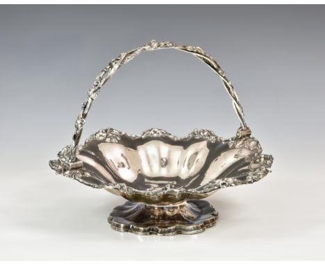 A 19th century silver plated lobed fruit bowl, of flower head form, with twisted vine swing handle, engraved lion crest to ce