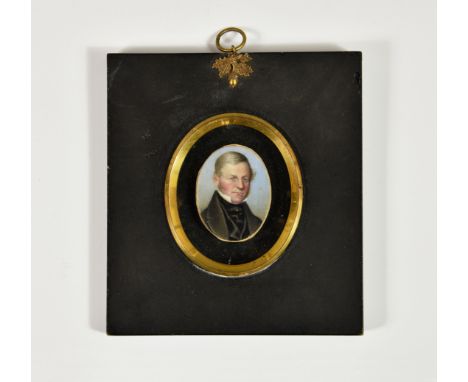 A mid-19th century portrait miniature of a gentleman, oval, watercolour on ivory, wearing a black coat, waistcoat and stock a