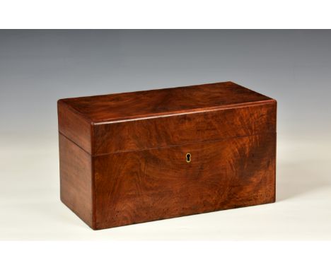 A Victorian walnut tea caddy, rectangular with chamfered edges, two arched canisters flanking a glass mixing bowl in fitted c