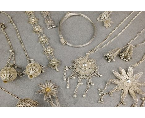 A collection of silver filigree jewellery, second half 20th century, probably from India or Pakistan, including two floral pe