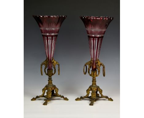 A pair of 19th century ruby cased glass and gilt metal vases, the trumpet vases with cut barbed rims and panel and comb cut d