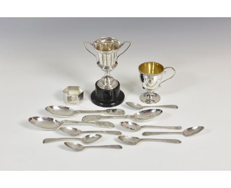 A collection of silver smalls, comprising a small trophy cup; three bright cut fiddle pattern dessert spoons, various makers 