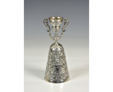 A Continental silver wager cup, probably Belgian, A835 grade silver, modelled as a figure in medieval dress holding a cup alo