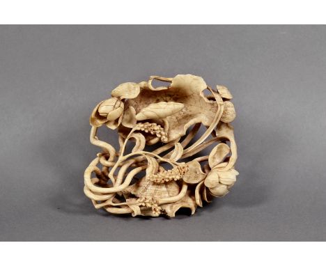 A Chinese openwork ivory carving of lotus blossoms and leaves, Qing Dynasty, amongst entwined stems, 4¾ x 4¼in. (12.1 x 10.8c