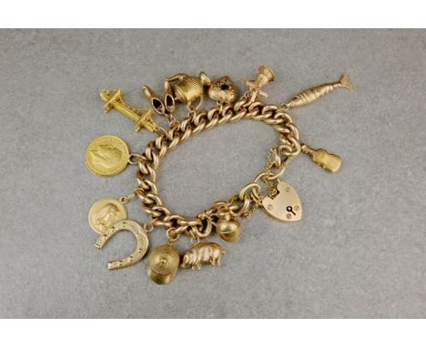 A 9ct gold charm bracelet, with heart padlock clasp, Birm. 1968, with various 9ct charms including an articulated fish, Guern
