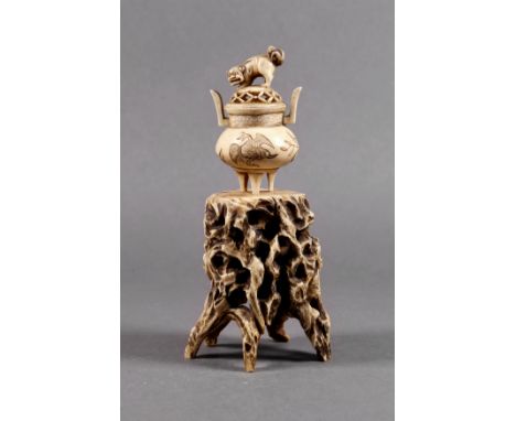 A Chinese carved ivory incense burner, Qing Dynasty, the tripod burner of archaic design, with a pierced lid, Dog of Fo finia