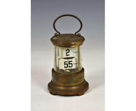 A gilt brass Plato or ticket clock, early 20th century, with two registers of tickets displaying the time within a cylindrica