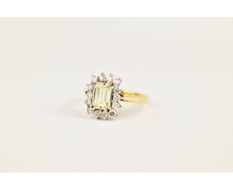 An 18ct yellow gold and emerald cut diamond cluster ring, featuring a light yellow emerald cut diamond weighing approximately