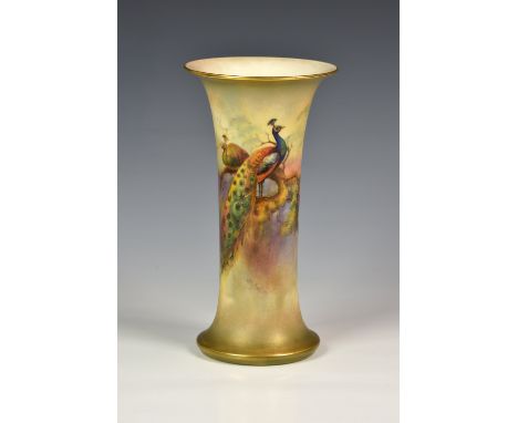 A Royal Worcester porcelain trumpet vase, painted with a pair of peacocks on a fir branch in a misty forest, signed 'W. H. Au