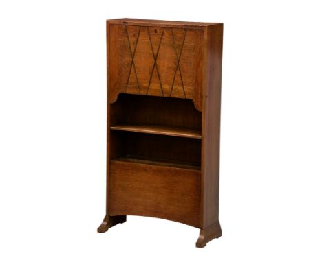 A 1920s oak students bureau, the carved fall front enclosing a partitioned interior, over a single open shelf with a tilting 