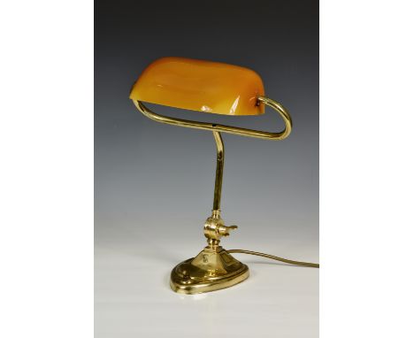 A brass library lamp, with a heart shaped base and amber shade, 15in. (38.1cm.) high. 