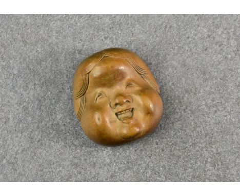 A Japanese boxwood double face netsuke of Okame and Hyottoko, Meiji period, with masks to either side, the front face depicti