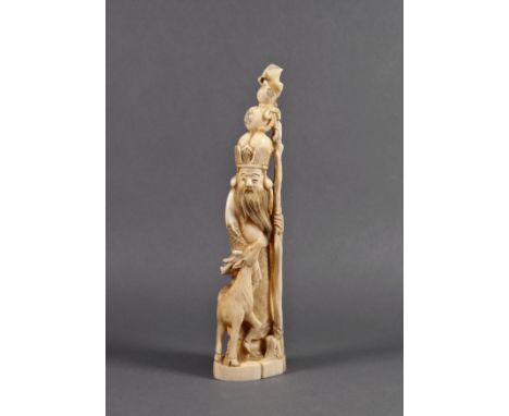 A Chinese carved ivory figure of Shou Lao, Qing Dynasty, standing with a deer at his side, on his hat rests a gourd which is 