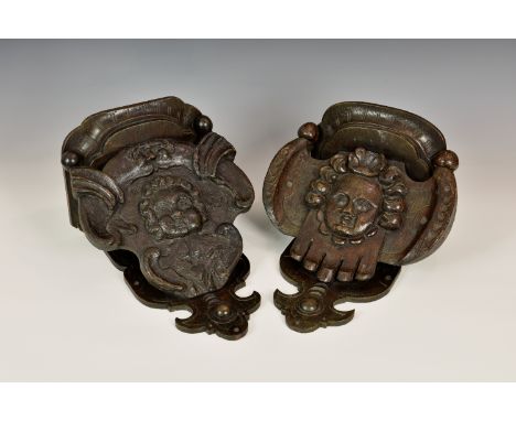 A matched pair of 19th century carved oak wall brackets, made using earlier carved elements, 12½in. and 13½in. (31.75cm. and 