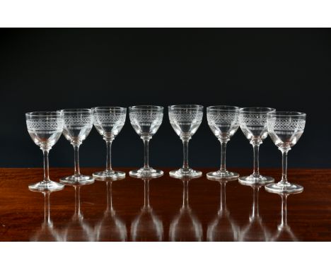 A set of eight Victorian wine or port glasses, the cup bowls with comb cutting below a lattice cut band, on a plain stem and 