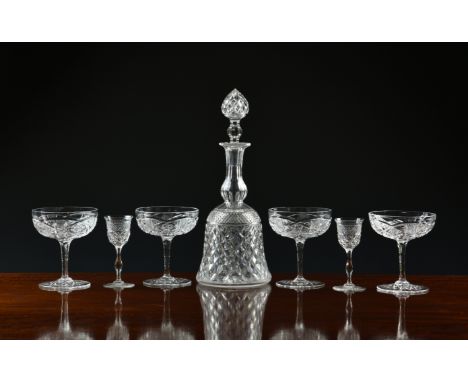 A cut glass bell shaped decanter, with cone stopper, 11¼in. (28.5cm.) high overall; together with a set of six matching diamo