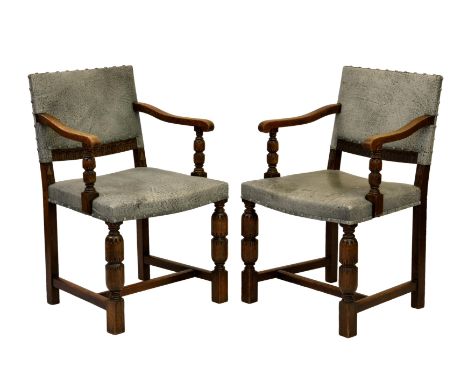 A pair of carved oak 17th century style dining chairs, early 20th century, the rectangular backs and stuff over seats upholst