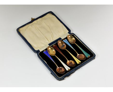 A cased set of six silver gilt and enamel coffee spoons, by David Andersen, Norway, with polychrome guilloche decoration to t