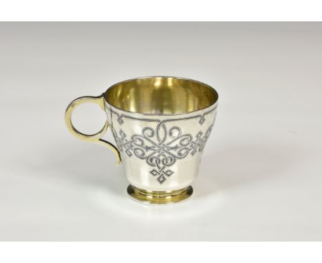 A Russian silver gilt Niello work cup, Moscow 1862, assay master 'B.C', ogee form with stylised niello scrollwork, the base l