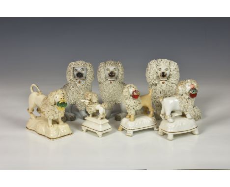Seven 19th century Staffordshire models of Poodles, comprising a hunting Poodle with bird in mouth, raised on stepped rectang