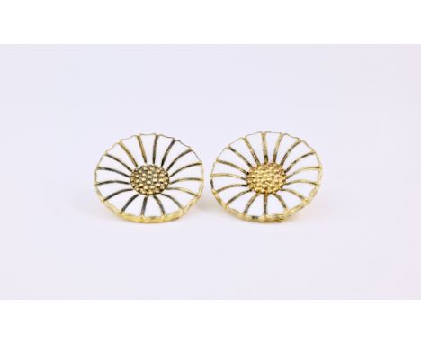 A pair of Georg Jensen daisy ear clips, made with silver gilt and white enamel and of daisy form and measuring approximately 