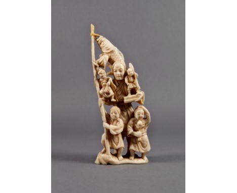 A Japanese carved ivory okimono of a fisherwoman, Meiji period (1868-1912), the elderly lady carrying two small demonic figur