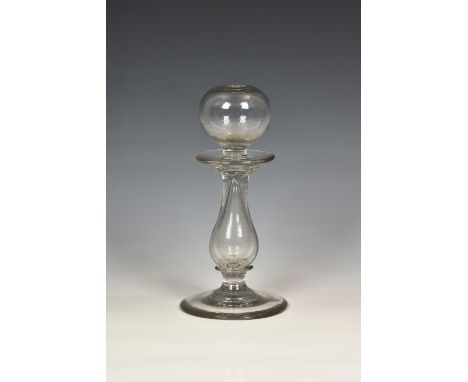 A 19th century hand blown clear glass lace maker's lamp, probably Continental, of baluster form with globular font, circular 
