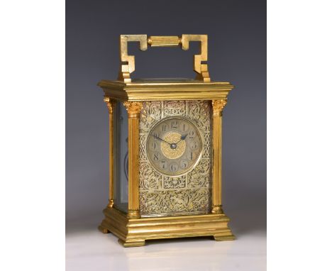 A mammoth gilt brass carriage clock, early 20th century, the Corinthian column case with folding reeded and keywork handle, t
