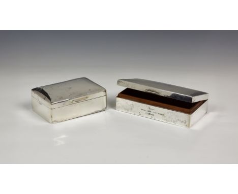 Two silver cigarette boxes, one of plain rounded rectangular form, Philip Hanson Abbot, London 1917; the other with engine tu