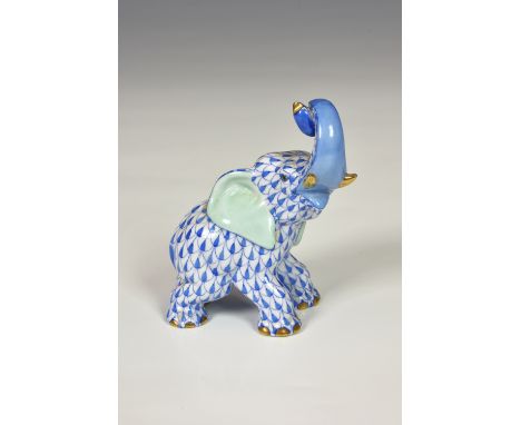 A Herend porcelain Elephant, trunk in air, hand painted in Vieux Herend (VHB) blue fish scale design, trunk and nails in gilt