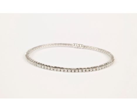 An 18ct white gold and diamond flexible bangle, featuring approximately 0.86tcw of brilliant cut diamonds held in high, 4 pro