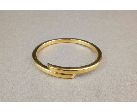 An Italian 18ct gold hinged bangle, the hollow, square section bangle with sprung hinge. 