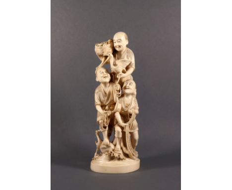 A Japanese carved ivory okimono of three fishermen, Meiji period (1868-1912), one with a basket of fish, another holding a ro