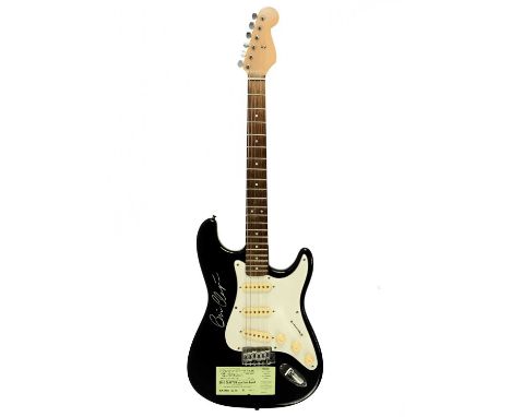 Signed; Eric Clapton electric guitar. A black stratocaster style guitar, signed by Clapton in silver marker. Acquired in 1983