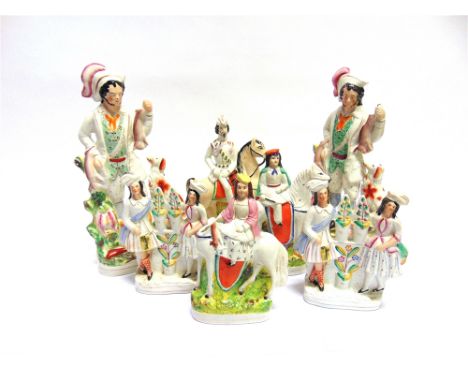 A GROUP OF SEVEN VICTORIAN STAFFORDSHIRE FIGURES  comprising three pairs and an equestrian group, the largest a pair of hunti