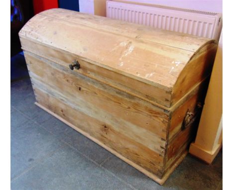 A LARGE DOME TOP PINE TRUNK  with brass carrying handles, 125cm long 63cm deep 78cm high