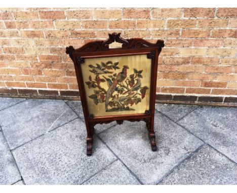 A CARVED MAHOGANY FRAMED FIRESCREEN  inset with needlework silk panel depicting birds, 60cm wide 88cm high, the panel 44cm wi