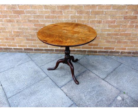 AN OAK TILT TOP TRIPOD OCCASIONAL TABLE  the circular top 80cm diameter, 72cm high