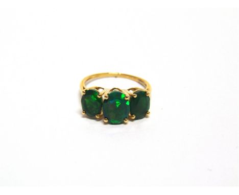 A 9 CARAT GOLD THREE STONE OPAL  finger size O, 2.5g gross