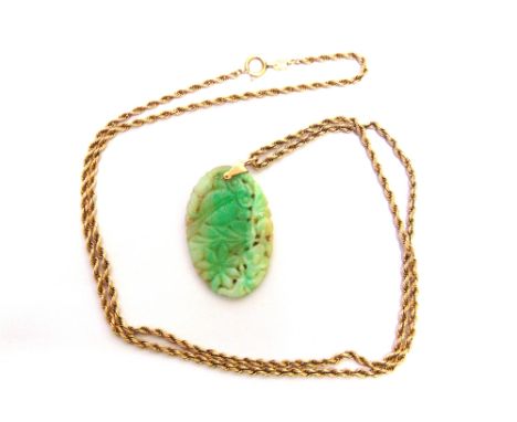 A JADE PANEL PENDANT the oval carved and pierced panel approximately 46mm by 30mm, bale unmarked; on a chain of solid rope li