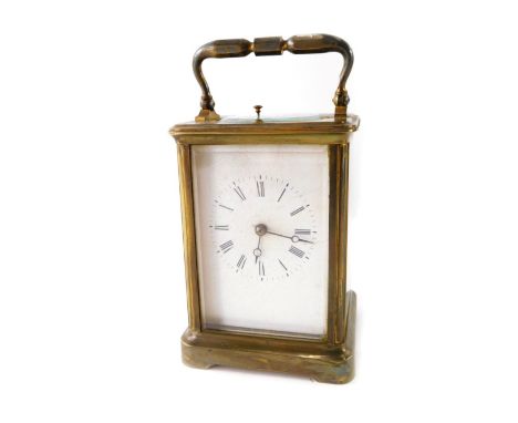 An early 20thC brass repeating carriage clock, of rectangular form with swing handle, the five part glazed case revealing bar