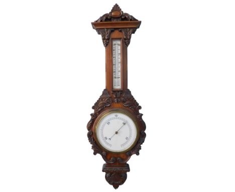 A 19thC mahogany two dial barometer, in a heavily carved case, surmounted by a vacant raised oval cartouche above thermometer